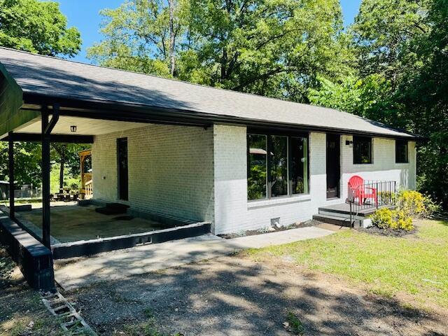 7015 Gamble Rd, Birchwood, TN 37308 - view of front of house featuring brick siding, driveway, a carport, and roof with shingles