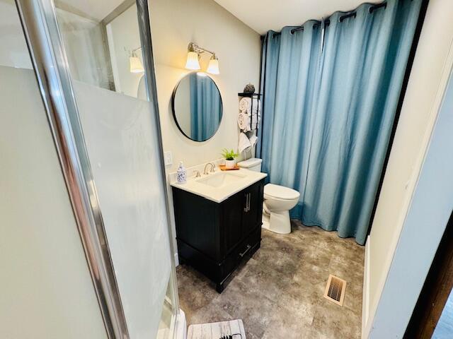 7015 Gamble Rd, Birchwood, TN 37308 - bathroom featuring vanity, a stall shower, and toilet