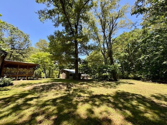 7015 Gamble Rd, Birchwood, TN 37308 - view of grassy yard featuring a wooden deck and an outdoor structure