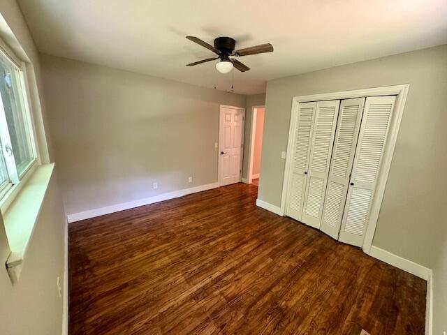 7015 Gamble Rd, Birchwood, TN 37308 - unfurnished bedroom featuring dark wood-style floors, baseboards, a closet, and ceiling fan