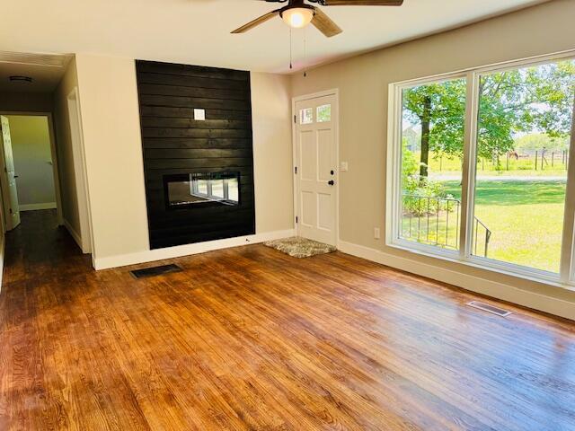 7015 Gamble Rd, Birchwood, TN 37308 - entryway featuring a multi sided fireplace, wood finished floors, a ceiling fan, and baseboards
