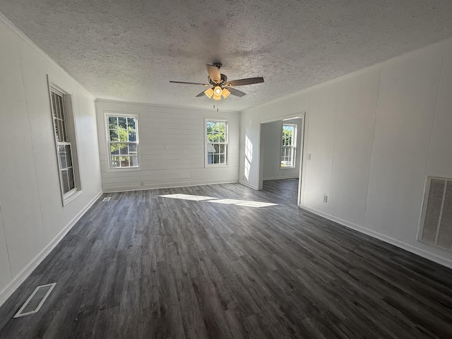 608 Bleeker St, Bridgeport, AL 35740 - unfurnished living room with dark wood-style floors, a textured ceiling, healthy amount of natural light, ceiling fan, and a decorative wall