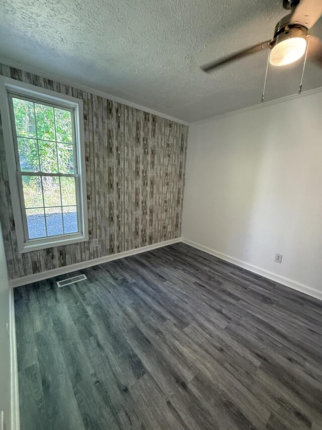 608 Bleeker St, Bridgeport, AL 35740 - unfurnished room with a textured ceiling, baseboards, dark wood-style floors, ceiling fan, and crown molding