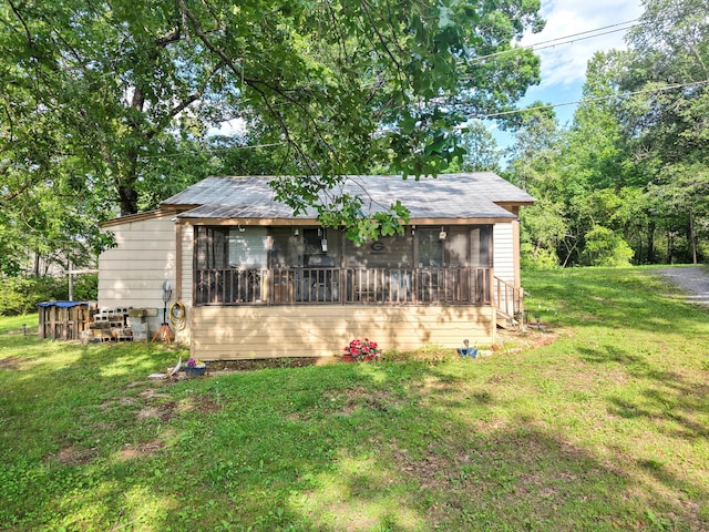 3650 Waring Rd, Dalton, GA 30721 - back of property featuring a sunroom and a lawn