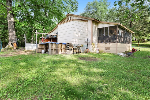 3650 Waring Rd, Dalton, GA 30721 - back of property featuring a sunroom, a lawn, and view of wooded area