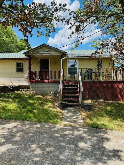 732 Hooper Rd, Ringgold, GA 30736 - view of front of property with covered porch, metal roof, and stairway