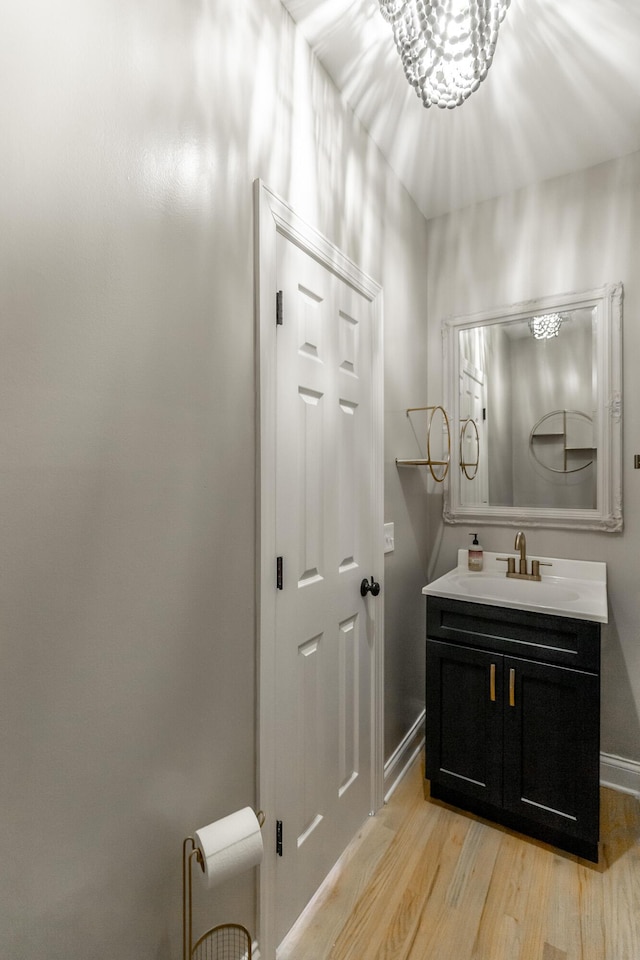 8102 Paces Ferry Xing, Chattanooga, TN 37421 - bathroom with wood finished floors, vanity, baseboards, and a chandelier