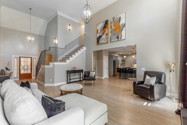 8102 Paces Ferry Xing, Chattanooga, TN 37421 - living area with high vaulted ceiling, stairway, light wood finished floors, crown molding, and baseboards
