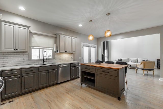 8102 Paces Ferry Xing, Chattanooga, TN 37421 - kitchen with stainless steel dishwasher, butcher block countertops, a sink, tasteful backsplash, and recessed lighting