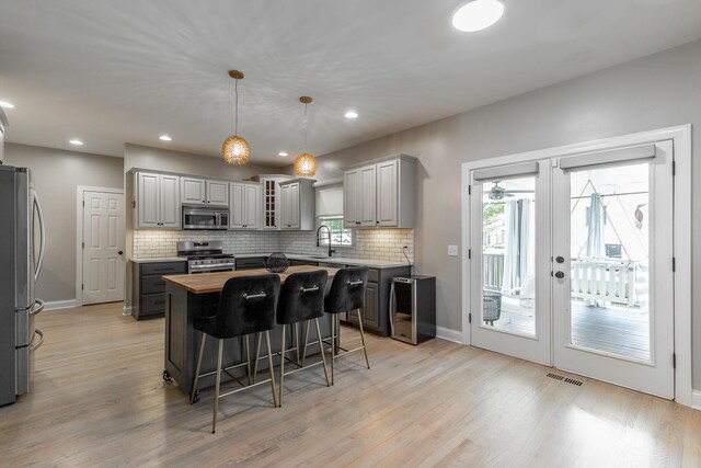 8102 Paces Ferry Xing, Chattanooga, TN 37421 - kitchen with stainless steel appliances, butcher block countertops, gray cabinetry, a sink, and baseboards