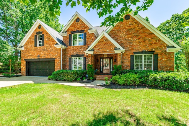 8102 Paces Ferry Xing, Chattanooga, TN 37421 - view of front facade featuring a garage, a front yard, concrete driveway, and brick siding