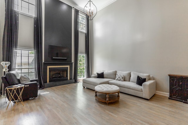 8102 Paces Ferry Xing, Chattanooga, TN 37421 - living room with a chandelier, a high ceiling, wood finished floors, crown molding, and plenty of natural light