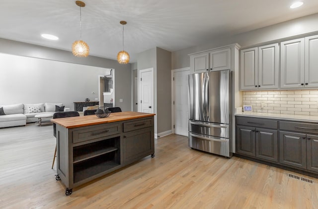 8102 Paces Ferry Xing, Chattanooga, TN 37421 - kitchen featuring freestanding refrigerator, butcher block countertops, open shelves, light wood finished floors, and tasteful backsplash