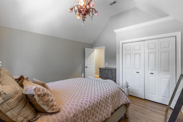 8102 Paces Ferry Xing, Chattanooga, TN 37421 - bedroom featuring vaulted ceiling, wood finished floors, a closet, and a chandelier