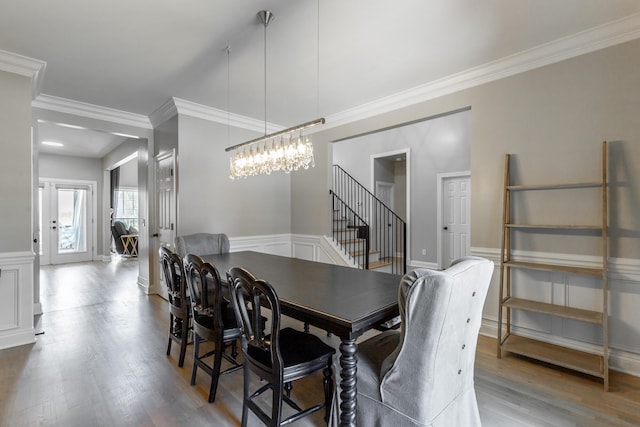 8102 Paces Ferry Xing, Chattanooga, TN 37421 - dining area with wood finished floors, crown molding, stairs, a decorative wall, and a wainscoted wall