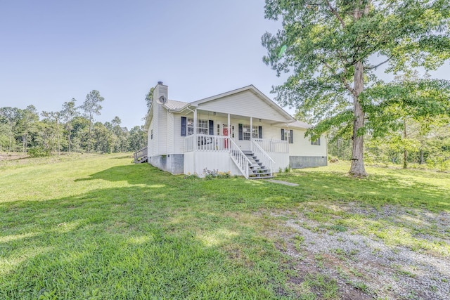 394 Nordic Rd, Crandall, GA 30711 - view of front facade with a chimney, covered porch, a front yard, and stairway