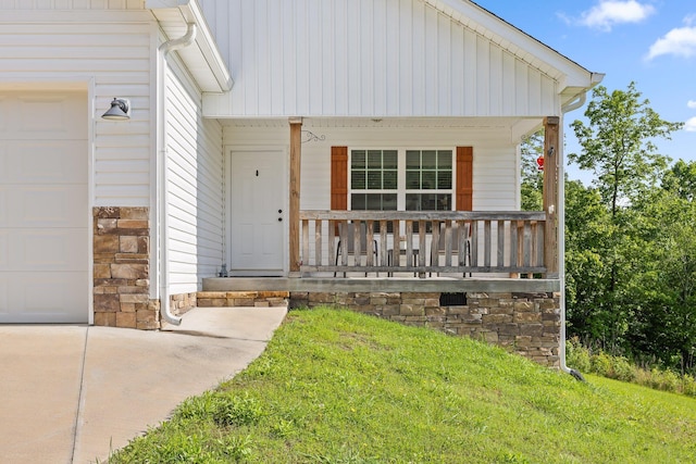 1008 Durgan Pl, Dalton, GA 30721 - view of front of house with a porch, a garage, a front yard, and stone siding
