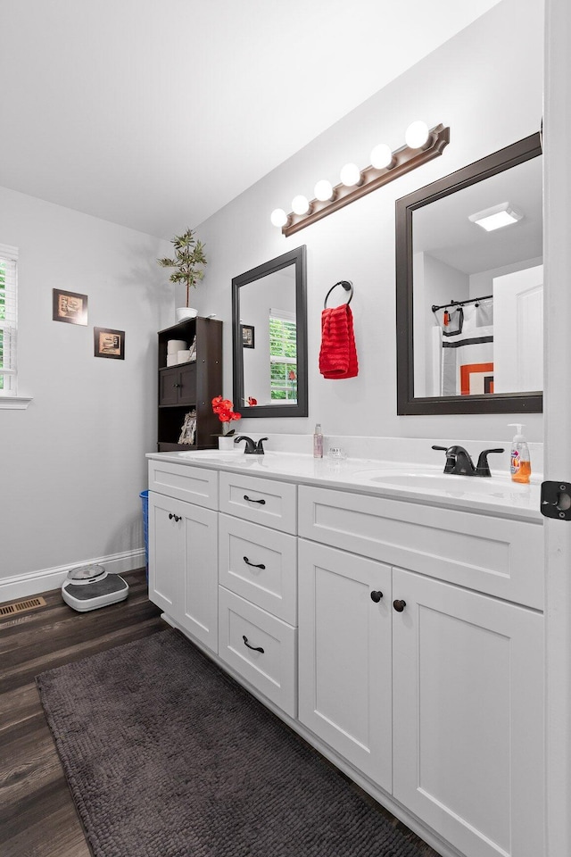 1008 Durgan Pl, Dalton, GA 30721 - full bath featuring double vanity, wood finished floors, and baseboards