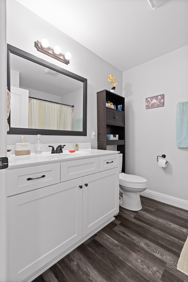 1008 Durgan Pl, Dalton, GA 30721 - full bath featuring vanity, wood finished floors, toilet, and baseboards