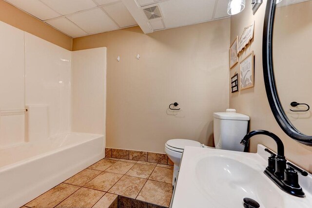 2049 Saunders Rd, Ringgold, GA 30736 - full bathroom with toilet, a sink, a paneled ceiling, baseboards, and tile patterned flooring