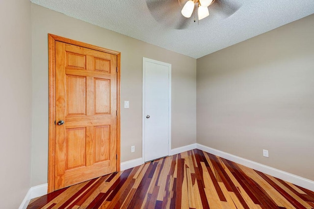 2049 Saunders Rd, Ringgold, GA 30736 - unfurnished bedroom featuring wood finished floors, baseboards, a textured ceiling, and ceiling fan