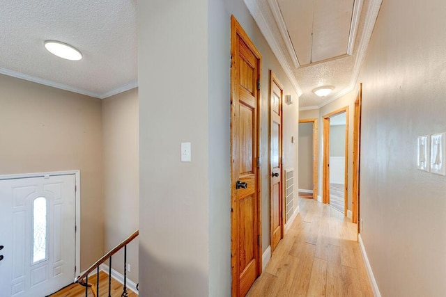 2049 Saunders Rd, Ringgold, GA 30736 - corridor with a textured ceiling, attic access, light wood-style floors, crown molding, and baseboards