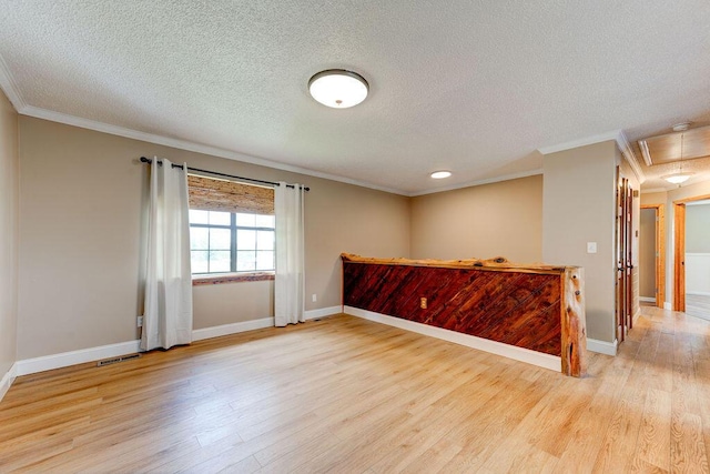 2049 Saunders Rd, Ringgold, GA 30736 - spare room featuring attic access, ornamental molding, wood finished floors, a textured ceiling, and baseboards