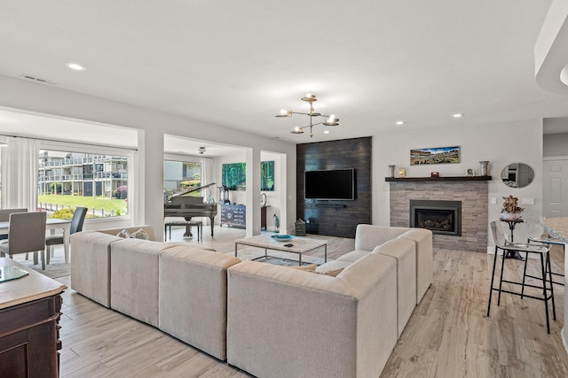 4274 Lakeshore Ln Unit 102, Chattanooga, TN 37415 - living room featuring light wood-style flooring, a chandelier, a stone fireplace, and recessed lighting