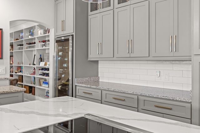 4274 Lakeshore Ln Unit 102, Chattanooga, TN 37415 - kitchen featuring gray cabinetry, wine cooler, decorative backsplash, and glass insert cabinets