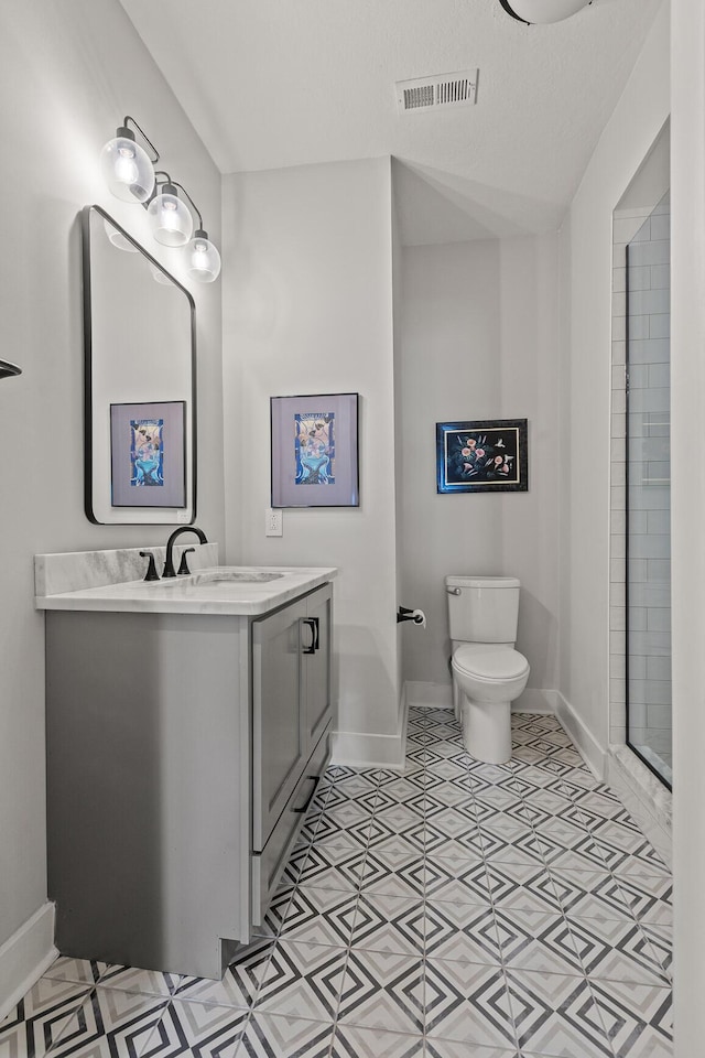 4274 Lakeshore Ln Unit 102, Chattanooga, TN 37415 - bathroom featuring baseboards, vanity, toilet, and a shower