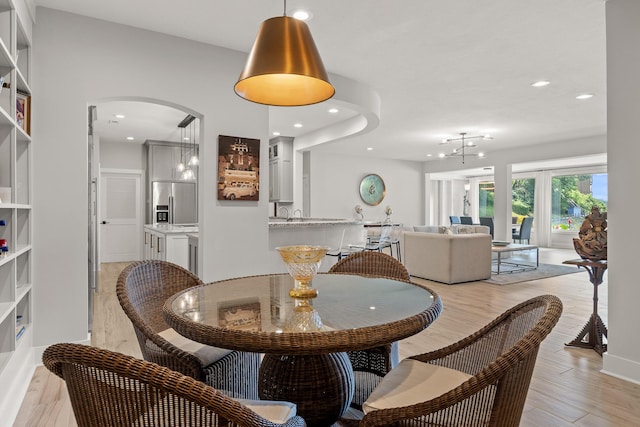 4274 Lakeshore Ln Unit 102, Chattanooga, TN 37415 - dining area featuring light wood finished floors, arched walkways, and recessed lighting