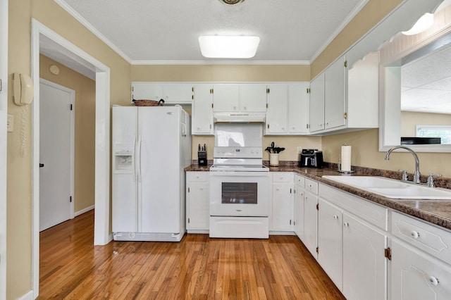 971 Hamilton Cir NW, Cleveland, TN 37312 - kitchen featuring white appliances, under cabinet range hood, a sink, dark countertops, and ornamental molding