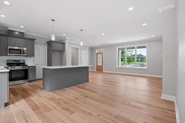 338 Kerry Ln, Soddy Daisy, TN 37379 - kitchen with stainless steel appliances, crown molding, gray cabinetry, light wood finished floors, and baseboards