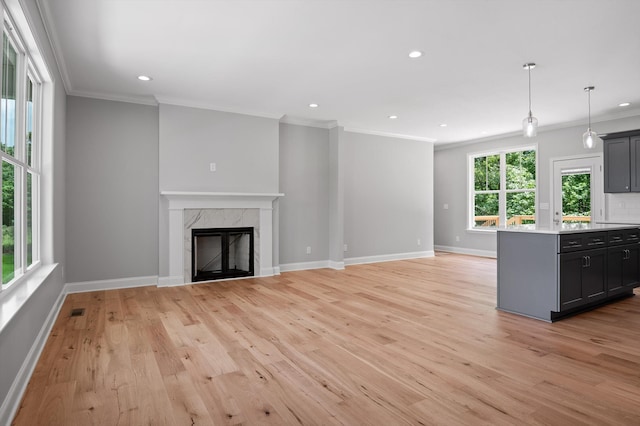 338 Kerry Ln, Soddy Daisy, TN 37379 - unfurnished living room with ornamental molding, light wood-type flooring, recessed lighting, baseboards, and a premium fireplace