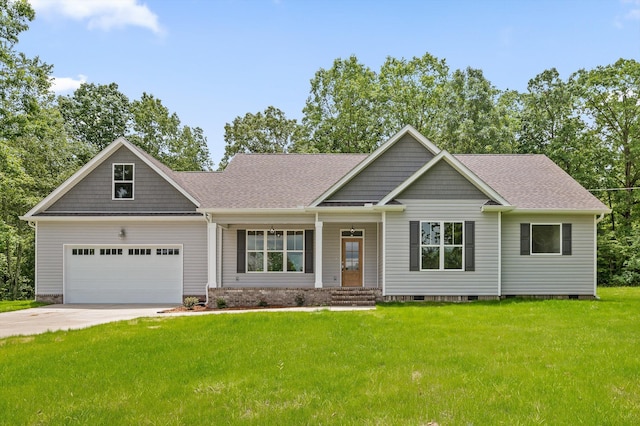 338 Kerry Ln, Soddy Daisy, TN 37379 - craftsman house featuring a front lawn, roof with shingles, driveway, and covered porch