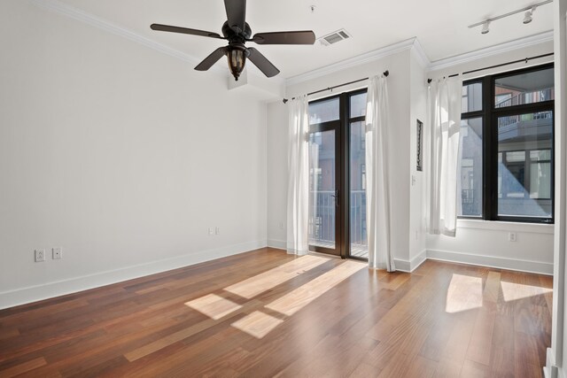129 Walnut St Unit 212, Chattanooga, TN 37403 - unfurnished room with crown molding, baseboards, wood finished floors, rail lighting, and ceiling fan