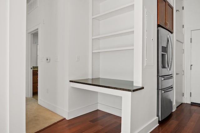 129 Walnut St Unit 212, Chattanooga, TN 37403 - kitchen featuring stainless steel fridge, dark wood-style flooring, dark countertops, baseboards, and a desk