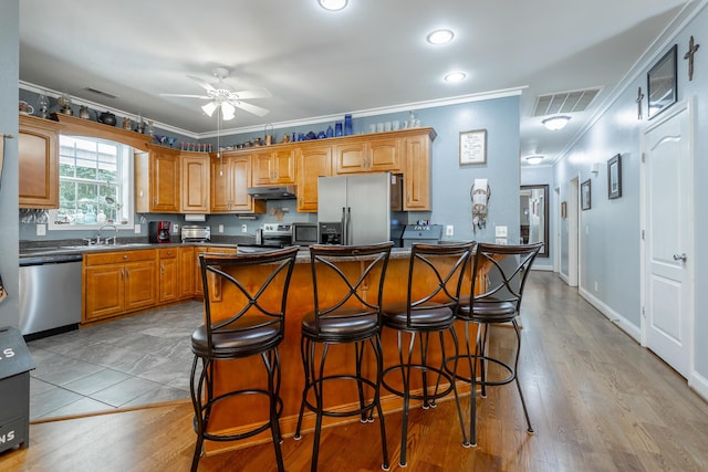 375 Cody Way, Tunnel Hill, GA 30755 - kitchen featuring stainless steel appliances, under cabinet range hood, ornamental molding, ceiling fan, and dark countertops