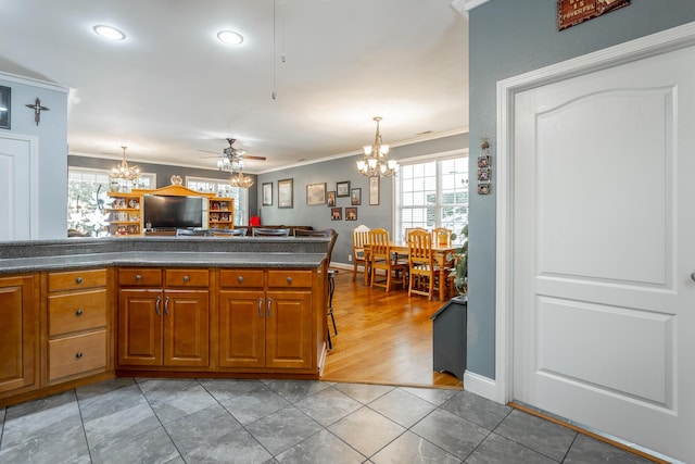 375 Cody Way, Tunnel Hill, GA 30755 - kitchen with a chandelier, dark countertops, crown molding, and brown cabinetry