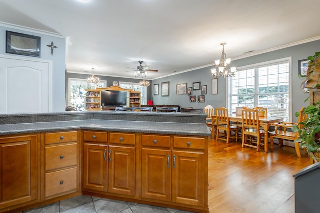 375 Cody Way, Tunnel Hill, GA 30755 - kitchen with a chandelier, dark countertops, crown molding, brown cabinetry, and hanging light fixtures