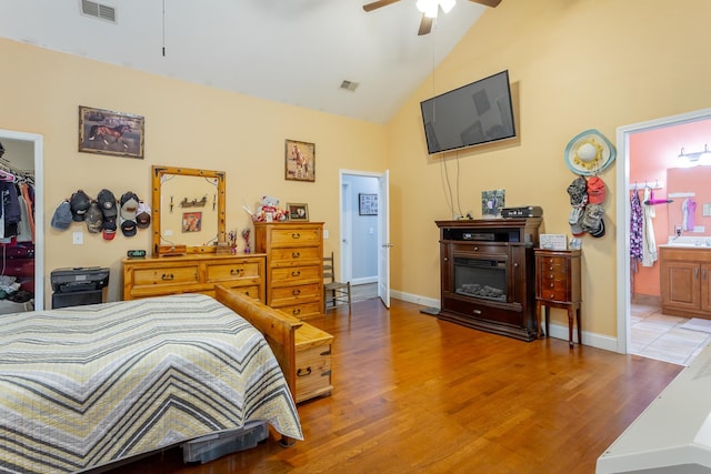 375 Cody Way, Tunnel Hill, GA 30755 - bedroom featuring wood finished floors, a walk in closet, a closet, ensuite bathroom, and high vaulted ceiling