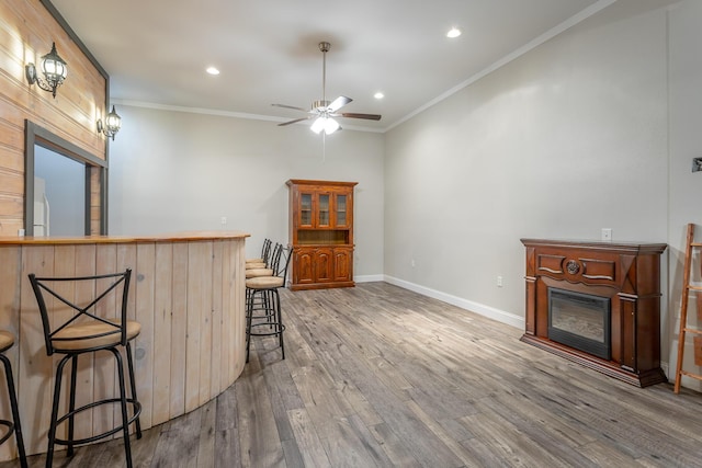 375 Cody Way, Tunnel Hill, GA 30755 - kitchen featuring a glass covered fireplace, wood finished floors, a kitchen bar, recessed lighting, and ceiling fan