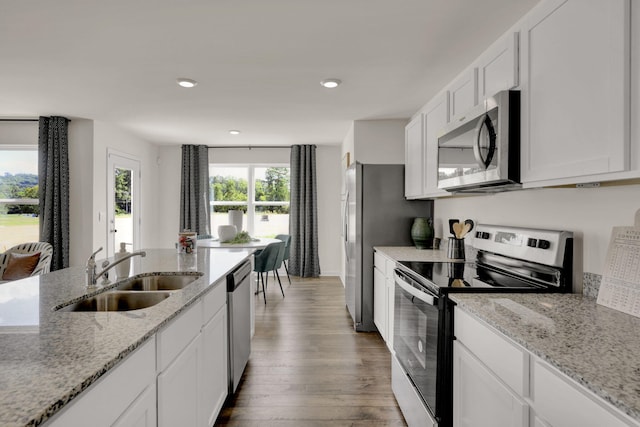 304 Draft St, Rossville, GA 30741 - kitchen with appliances with stainless steel finishes, a sink, wood finished floors, white cabinetry, and light stone counters