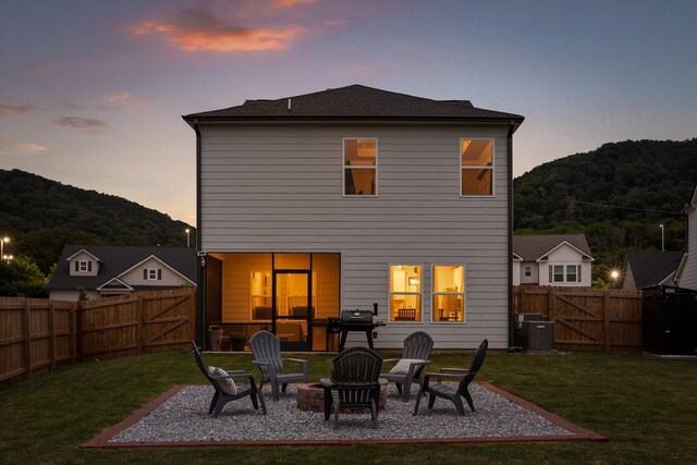 7559 Snow Cone Way, Ooltewah, TN 37363 - back of house at dusk with a gate, a patio, and central AC unit