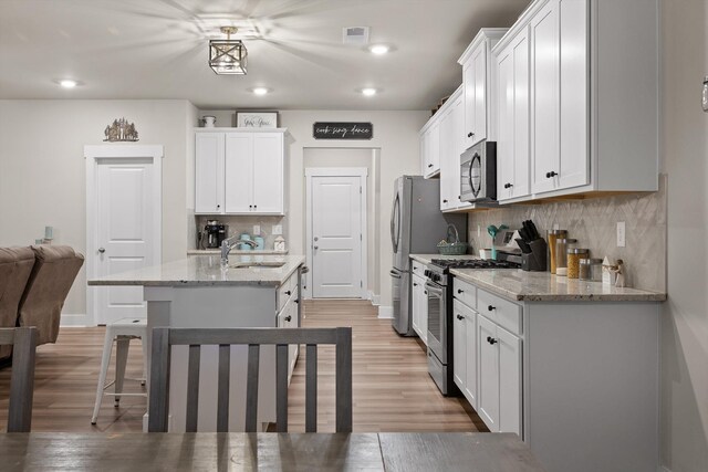 7559 Snow Cone Way, Ooltewah, TN 37363 - kitchen featuring stainless steel appliances, a sink, light wood-type flooring, backsplash, and recessed lighting