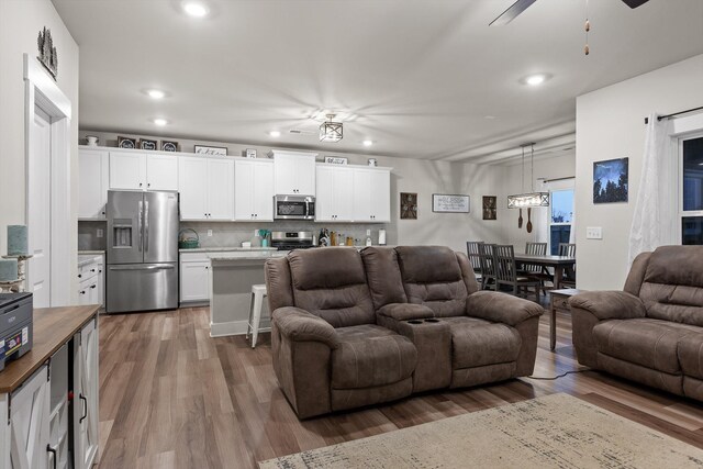 7559 Snow Cone Way, Ooltewah, TN 37363 - living area featuring wood finished floors, ceiling fan, and recessed lighting