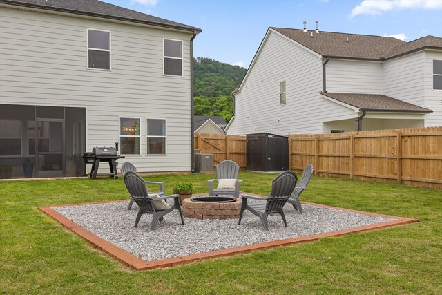 7559 Snow Cone Way, Ooltewah, TN 37363 - back of property featuring central AC unit, a patio, and an outdoor fire pit