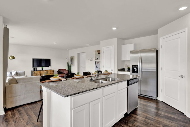 300 Draft St, Rossville, GA 30741 - kitchen featuring stainless steel appliances, a sink, dark stone counters, white cabinetry, and a center island with sink