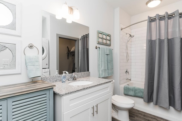 804 Riverfront Pkwy Unit 307, Chattanooga, TN 37402 - full bathroom with stacked washer / drying machine, shower / bath combo with shower curtain, vanity, toilet, and wood finished floors