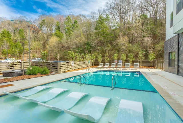 804 Riverfront Pkwy Unit 307, Chattanooga, TN 37402 - community pool featuring a fenced backyard and view of scattered trees